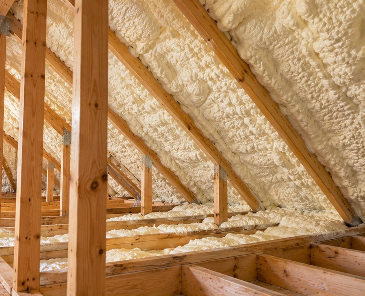 Spray foam insulation between attic roof rafters in Bedford, MA