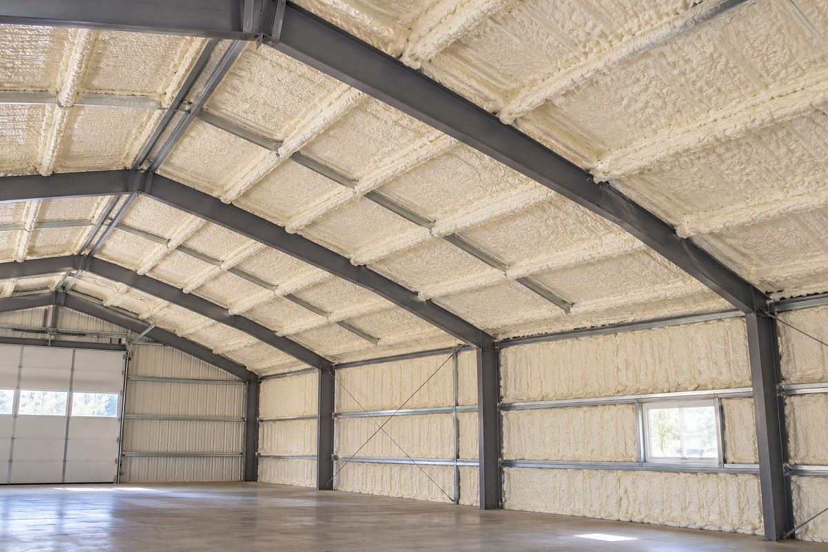 Spray foam insulation covering metal building walls and ceiling in Bedford, MA