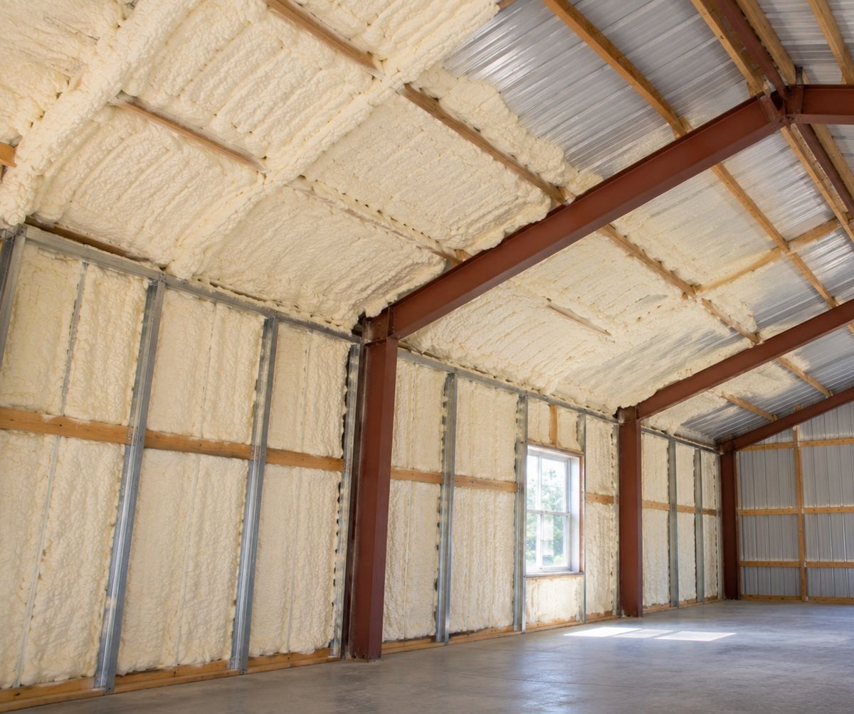 Partially insulated metal building with spray foam on walls and roof in Bedford, MA