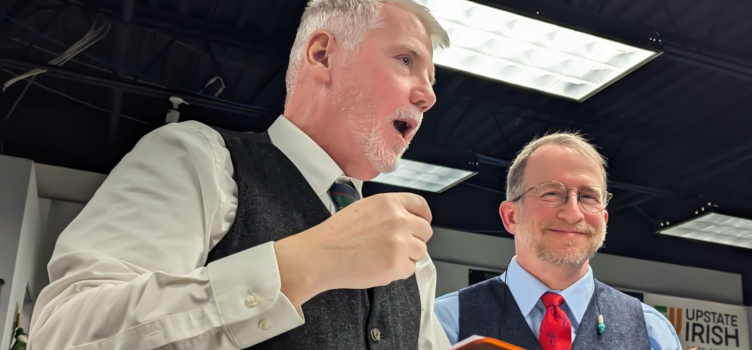 Two men speaking on a stage