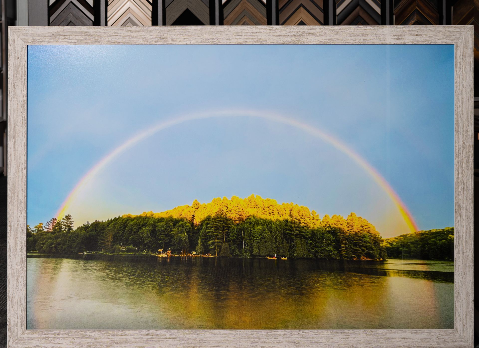 Custom framed landscape photograph of a rainbow over a lake