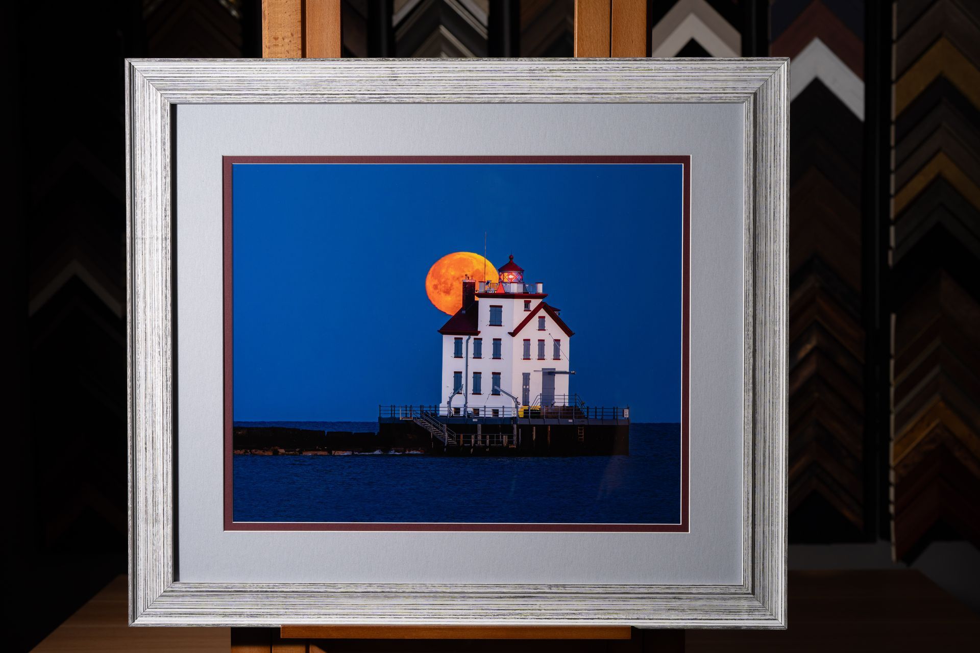Custom framed lighthouse artwork with blue and white matting
