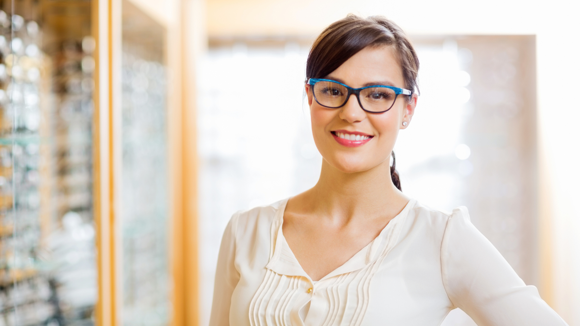 Woman smiling towards camera wearing glasses. 