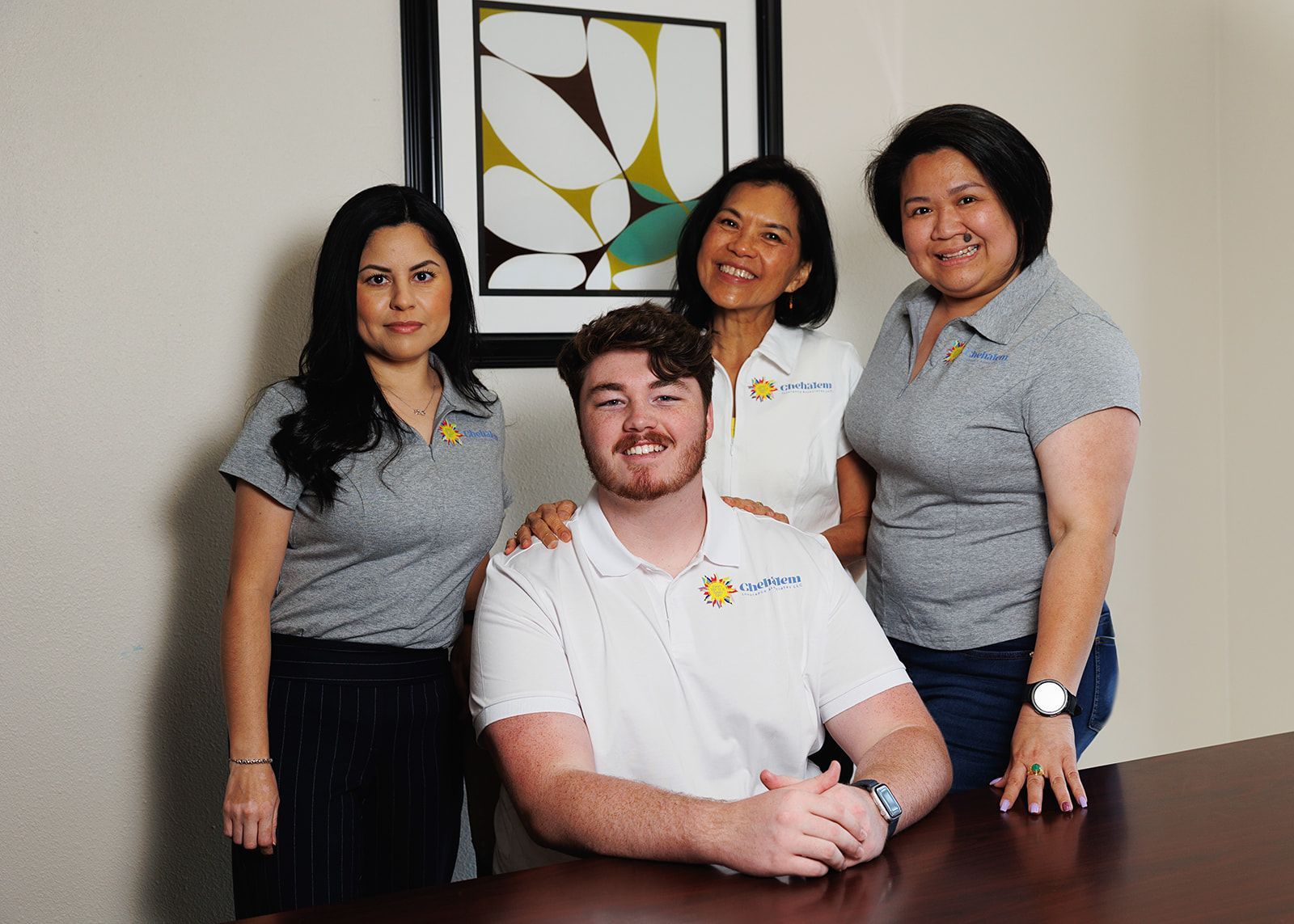 The whole Chehalem Insurance Associate crew. From left to right, Gabbi, Om, Sai, and Preston seated in the middle.