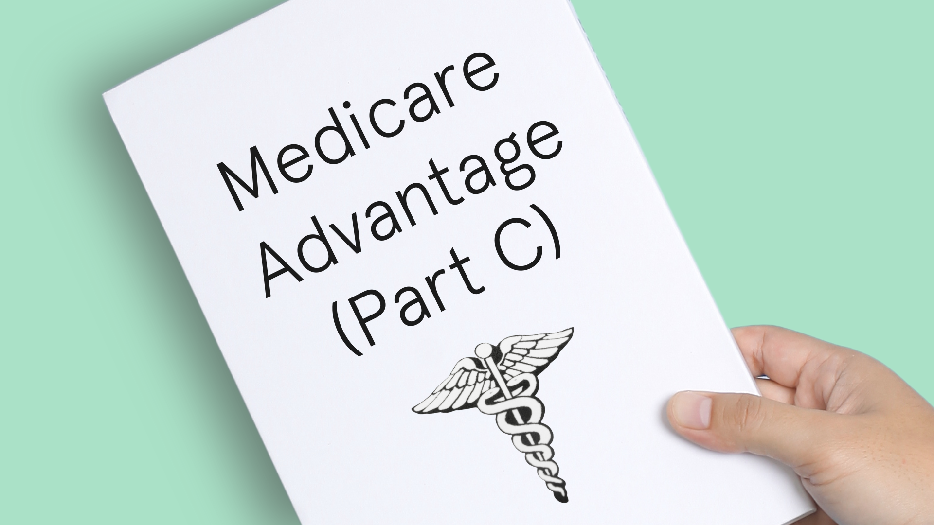 Hand holding a piece of paper over a light green background that reads Medicare Advantage (Part C).