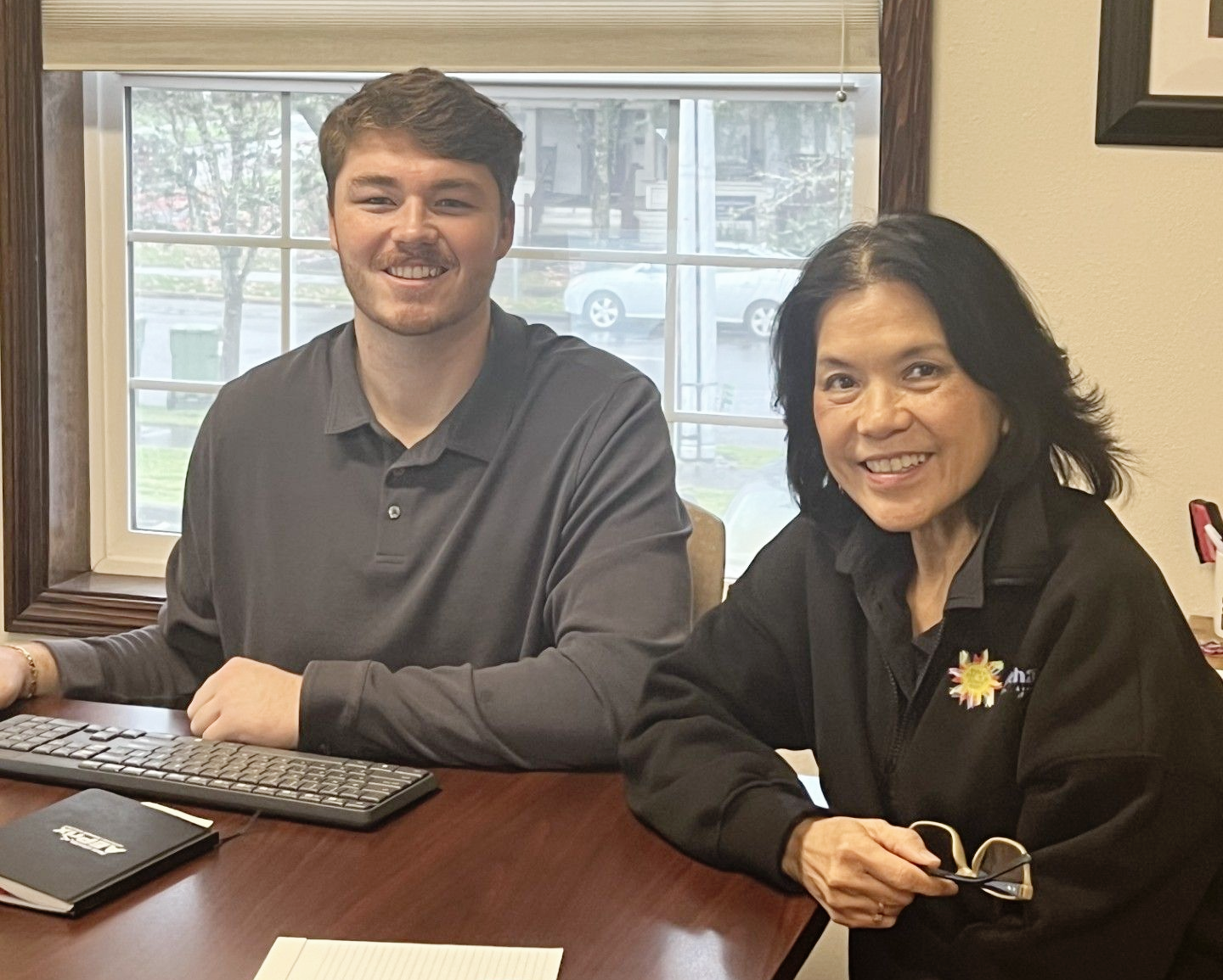 Preston Gullum and Om Sukheenai of Chehalem Insurance Associates in Newberg reviewing 2026 insurance needs.