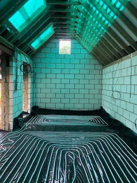 Underfloor heating in a brick extension before flooring is installed.
