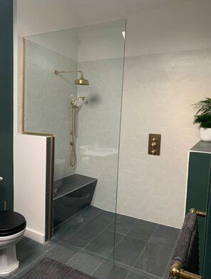 Renovated bathroom shower with tiled floor.