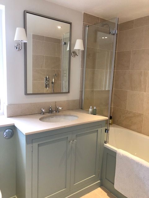 Bathroom plumbing works with a renovated heritage property bath, sink, and mirror.