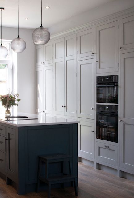 Renovated kitchen with new wood effect flooring.