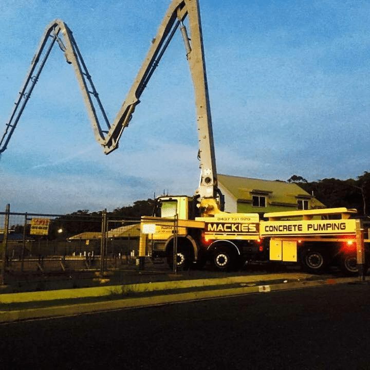 A Mackie's Concrete Pumping Truck is Parked on the Side of the Road — Mackie's Concrete Pumping In Pampoolah, NSW