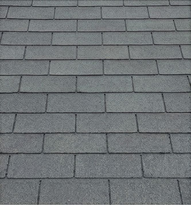 Gray asphalt shingles after cleaning, with reduced dark staining