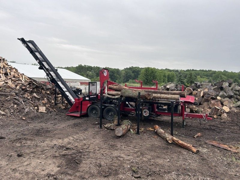 Firewood processor splitting logs at job site in Bristol, WI