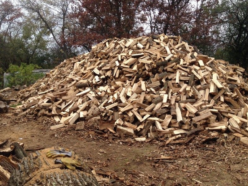 Large pile of split firewood ready for delivery at Haas Tree Service
