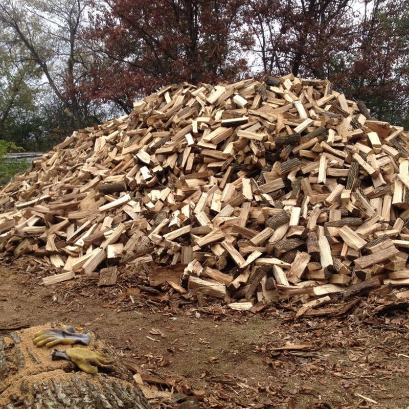 Large pile of split firewood ready for delivery at Haas Tree Service
