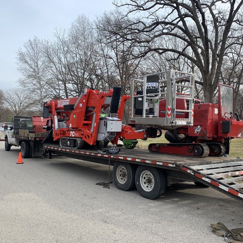 Two bucket trucks parked together during a tree limb pruning job in Pleasant Prairie, WI