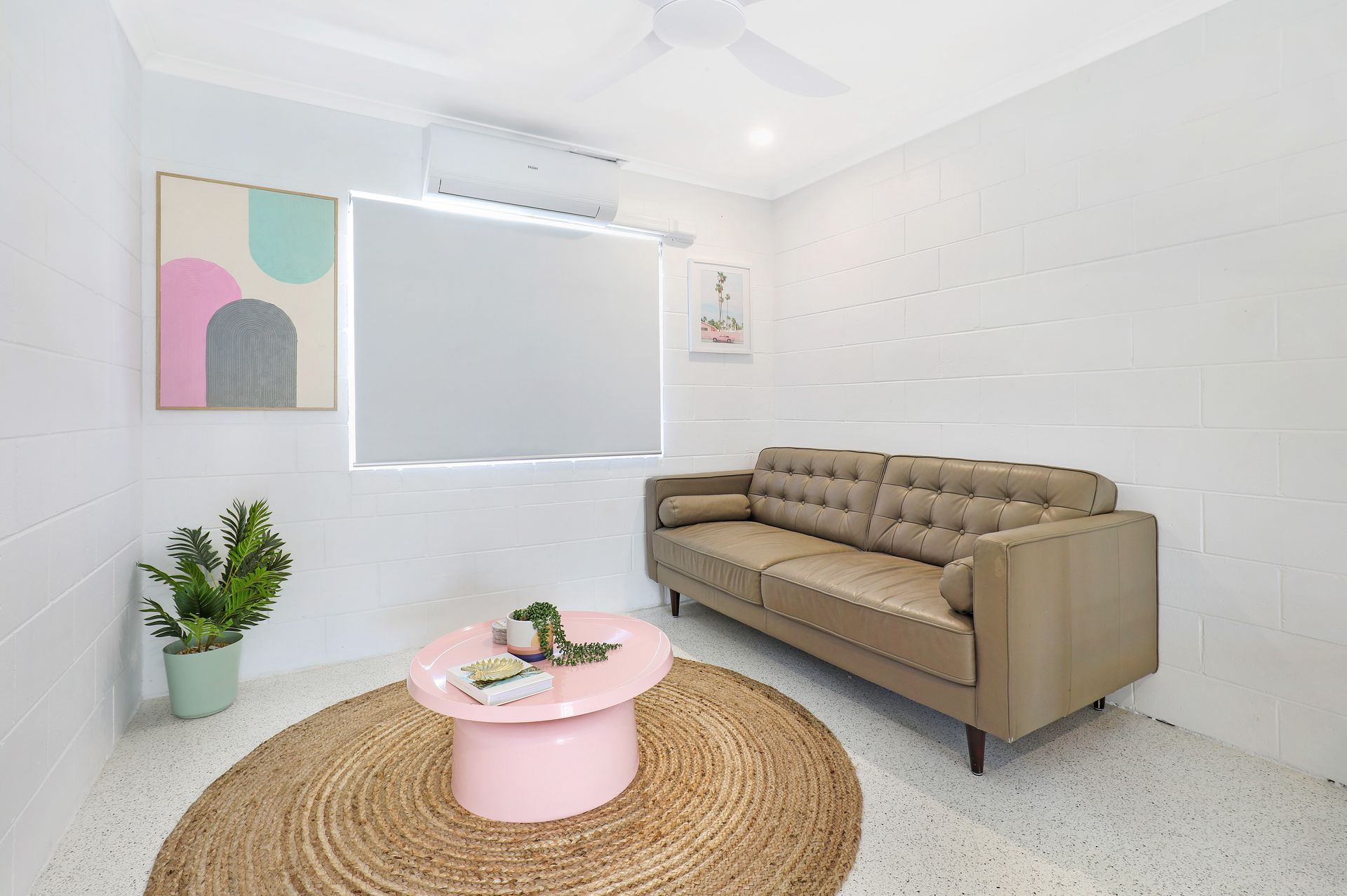 A living room with a couch , coffee table and rug.