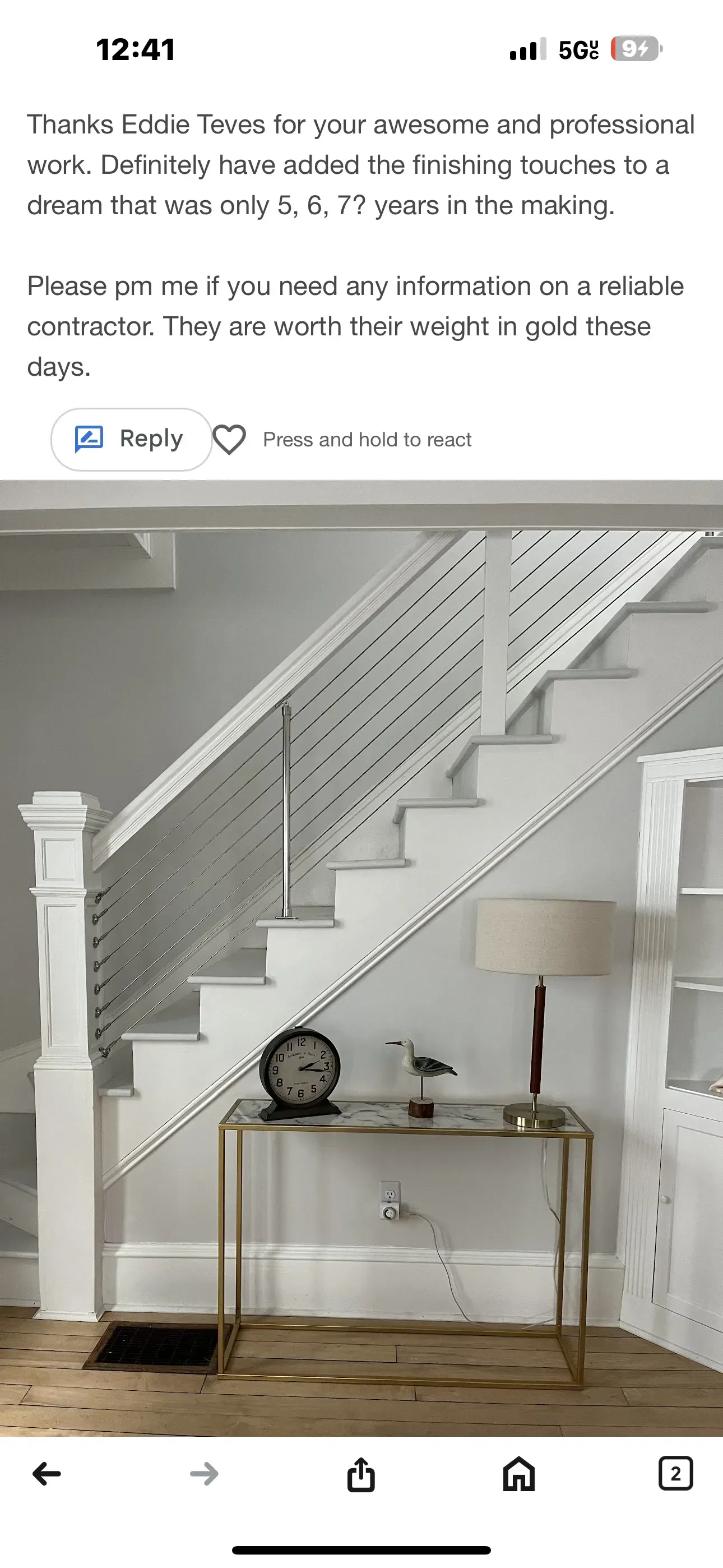 Staircase with white railing beside a small wall-mounted shelf and decor in a bright room