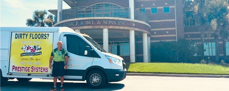 Man in a kilt stands by a van that says, 