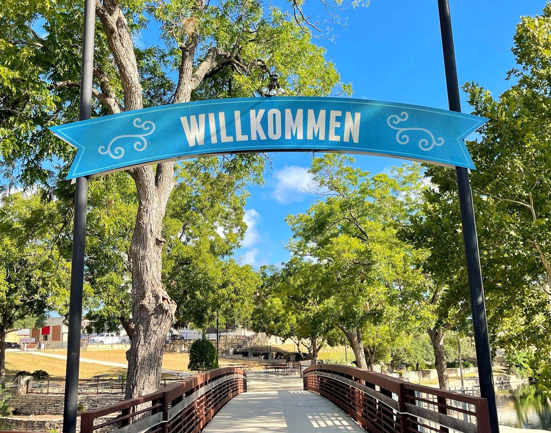 A bridge with a sign that says willkommen on it