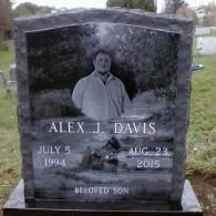 A gravestone with a picture of a man and a dog on it.