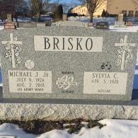 A gravestone for a man named brisco in a cemetery.