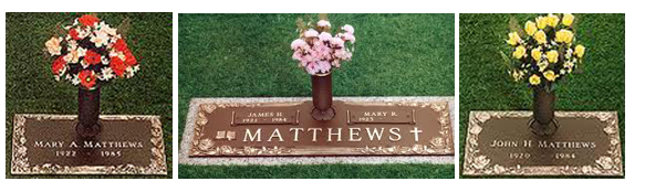 Three grave markers with flowers on them for matthews