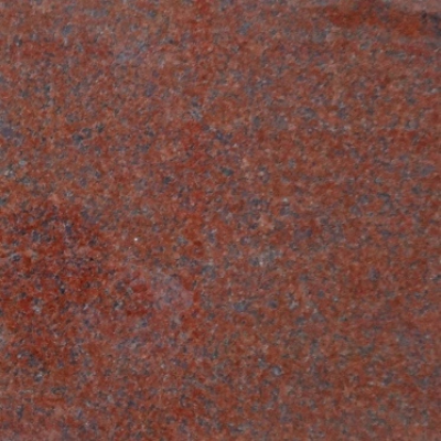 A close up of a piece of red granite.