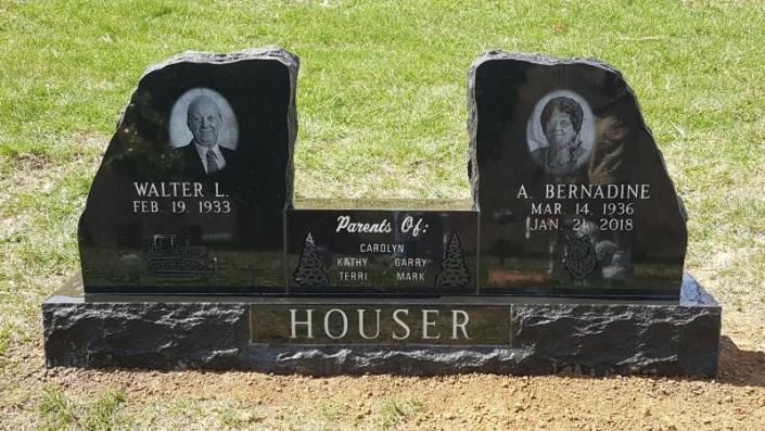 A gravestone for walter and a bernadine houser in a cemetery.