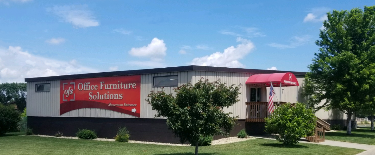 A mobile home with a red awning on the side of it.