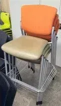 A stack of chairs tied together with rope in a room.