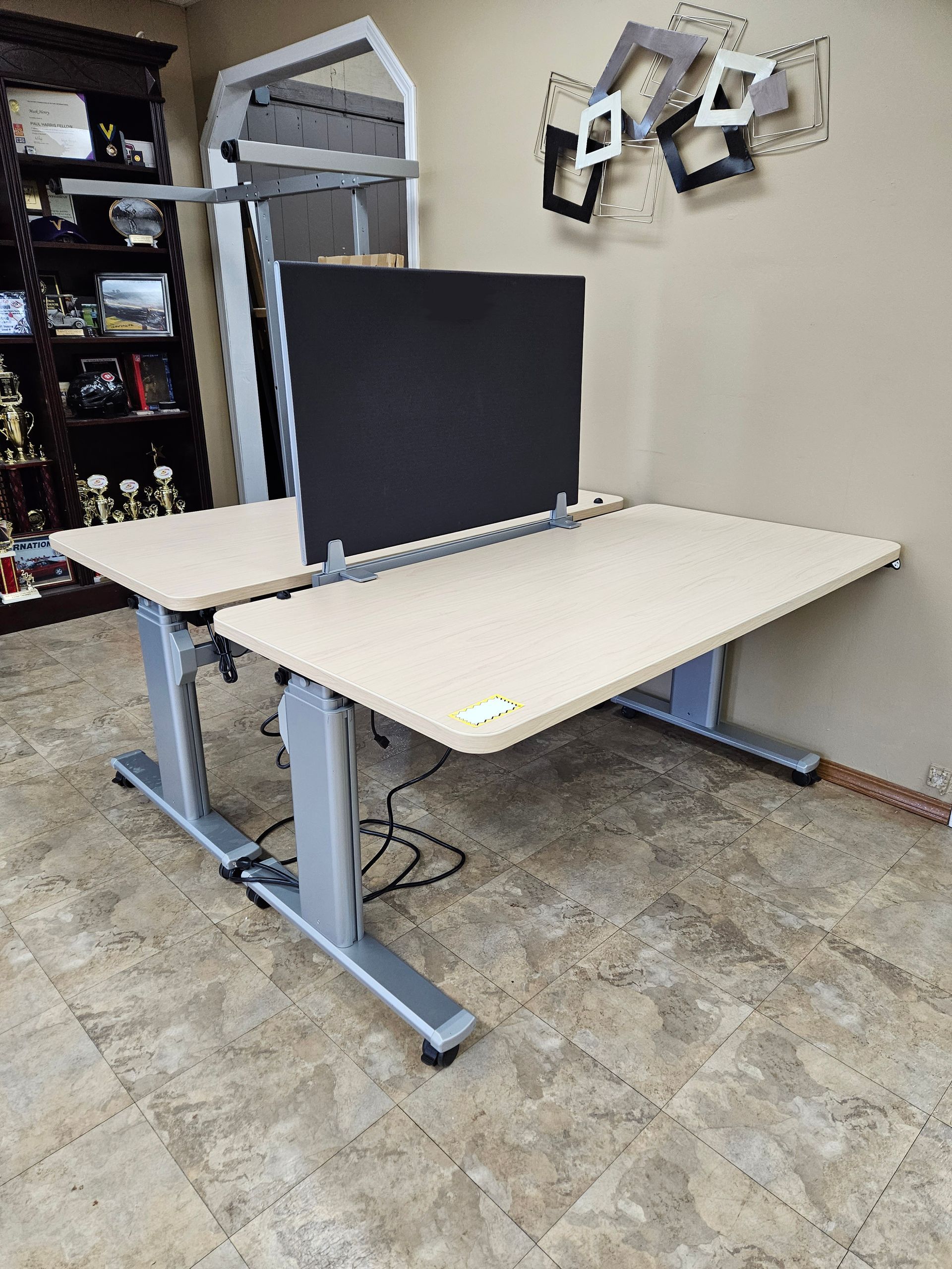 Two standing desks are sitting next to each other in a room.