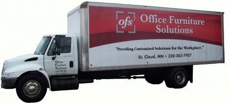 A white and red office furniture solutions truck