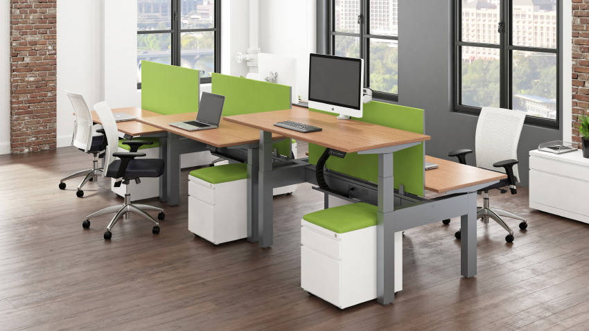 An office with a lot of desks and chairs and a computer on each desk.