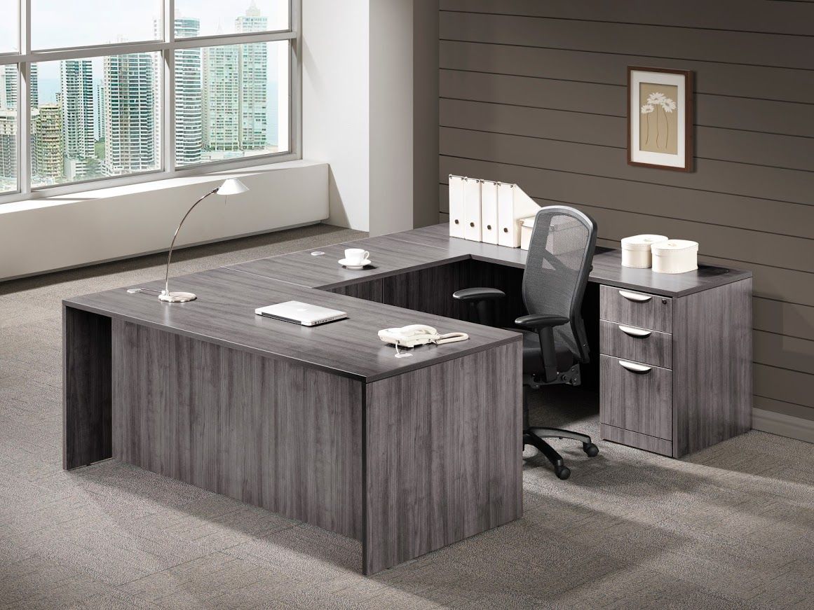 An office with a desk and chair in front of a window