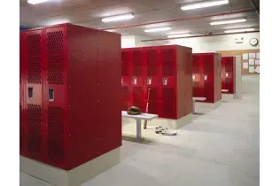 A row of red lockers in a locker room