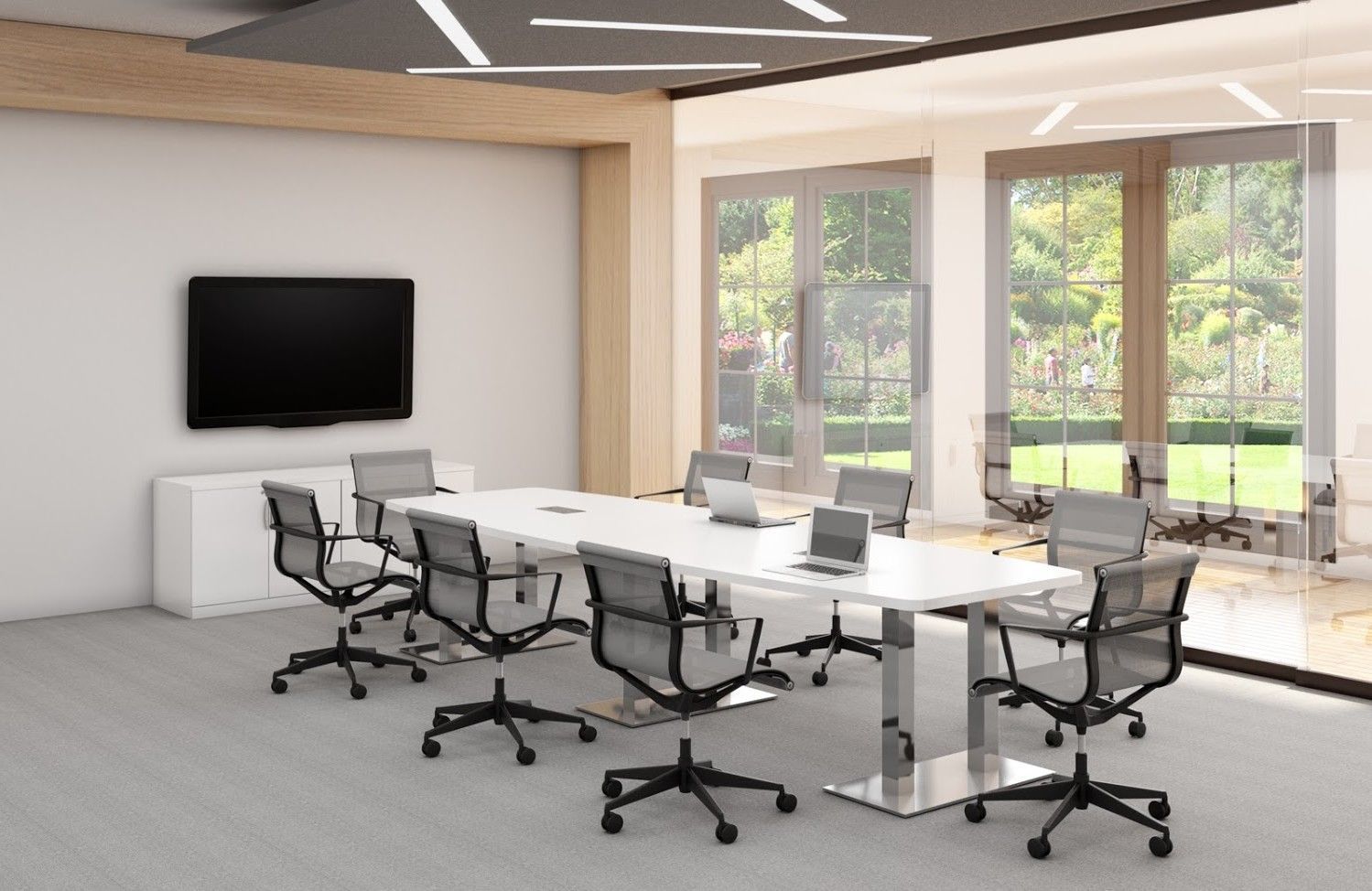 A conference room with a long table and chairs and a flat screen tv.