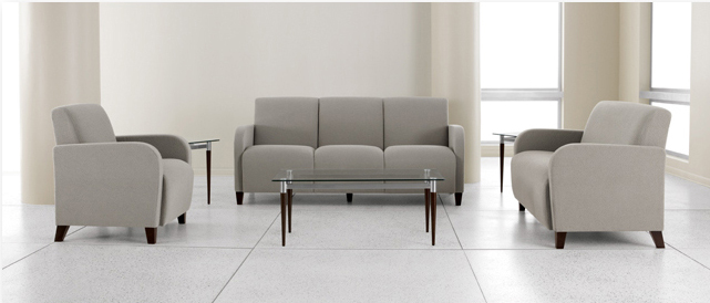 A living room with a couch , chairs , and a coffee table.