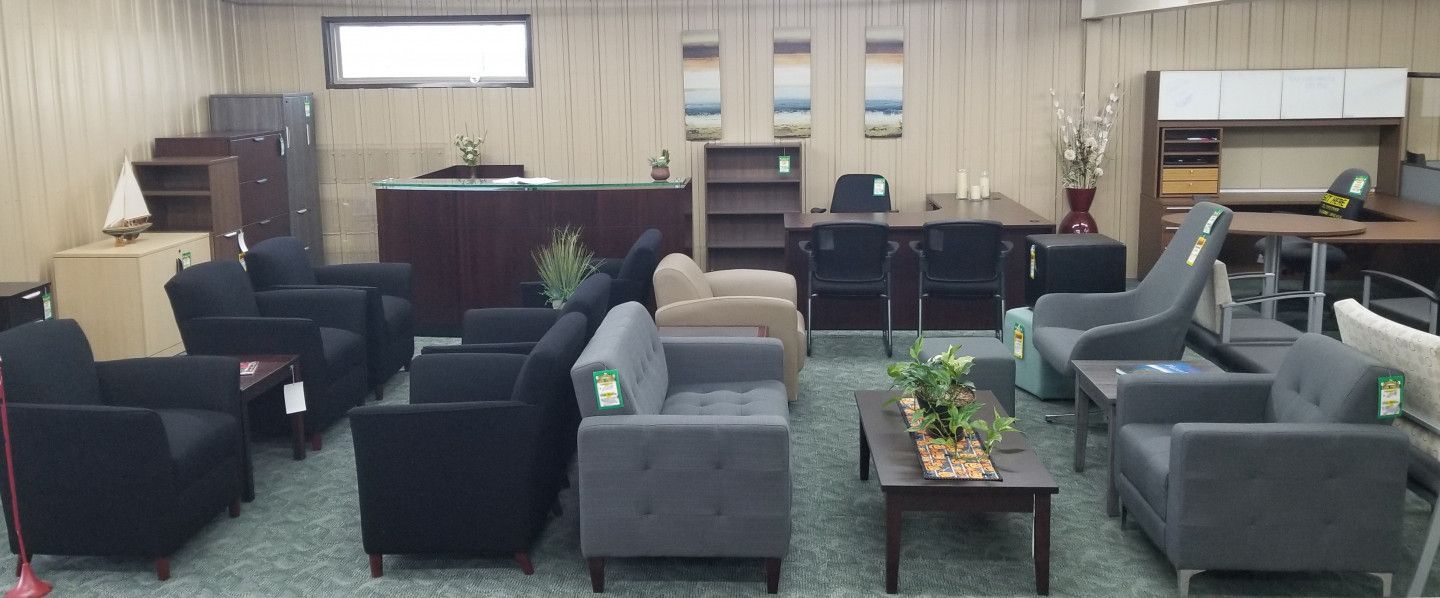 A room filled with furniture including a couch , chairs , tables and a mop.