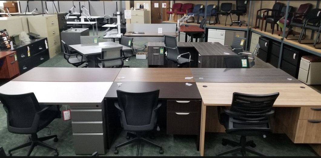 A warehouse filled with lots of desks and chairs