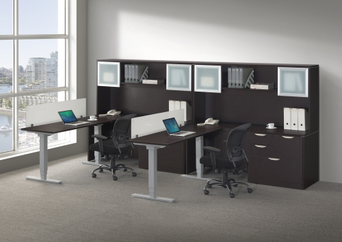A room with two desks and two chairs with laptops on them