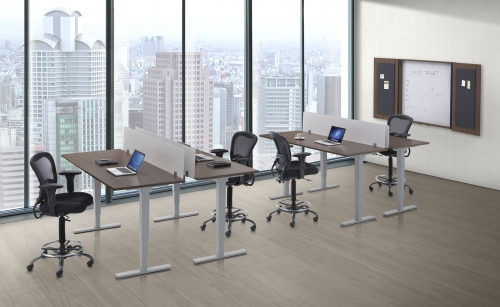 A room with a lot of windows and tables and chairs.