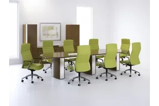 A conference room with a long table and green chairs.