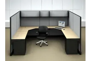 A cubicle with a chair and a computer on it