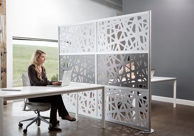 A woman is sitting at a desk with a laptop.