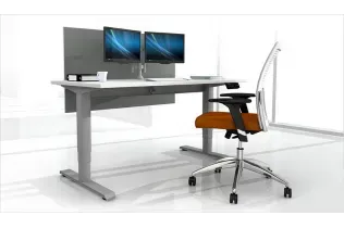 A computer desk with two monitors and an orange chair