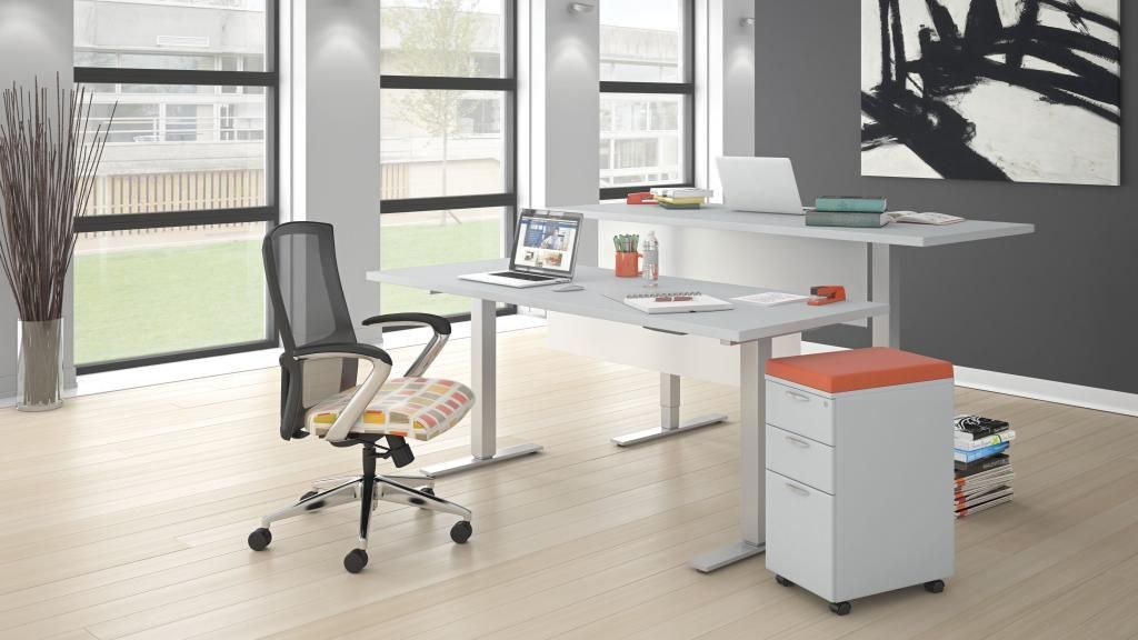 A room with two standing desks and a chair.