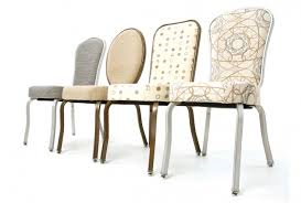 Four chairs are lined up in a row on a white background.