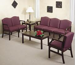 A living room with purple furniture and a coffee table.