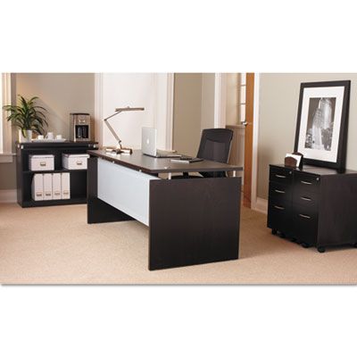 A desk with a laptop on it in an office
